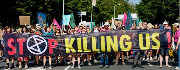 XR Netherlands cutting the road with "Stop Killings Us" sign