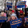 People hold signs during a "Save the Civil Service" rally outside the U.S. Capitol on Feb. 11.