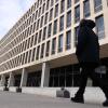 A man walks past the U.S. Department of Education building in Washington, D.C., on February 7. The building is about six stories tall and has rows of tall narrow windows.