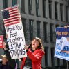 Protesters hold signs in solidarity at a rally in support of federal workers at the Office of Personnel Management in Washington, D.C., on March 4.