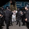 Guards escort one of the hundreds of alleged members of the 'Tren De Aragua' and Mara Salvatrucha gangs who were deported from the U.S. to El Salvador.