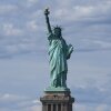 The Statue of Liberty pictured against a blue sky.