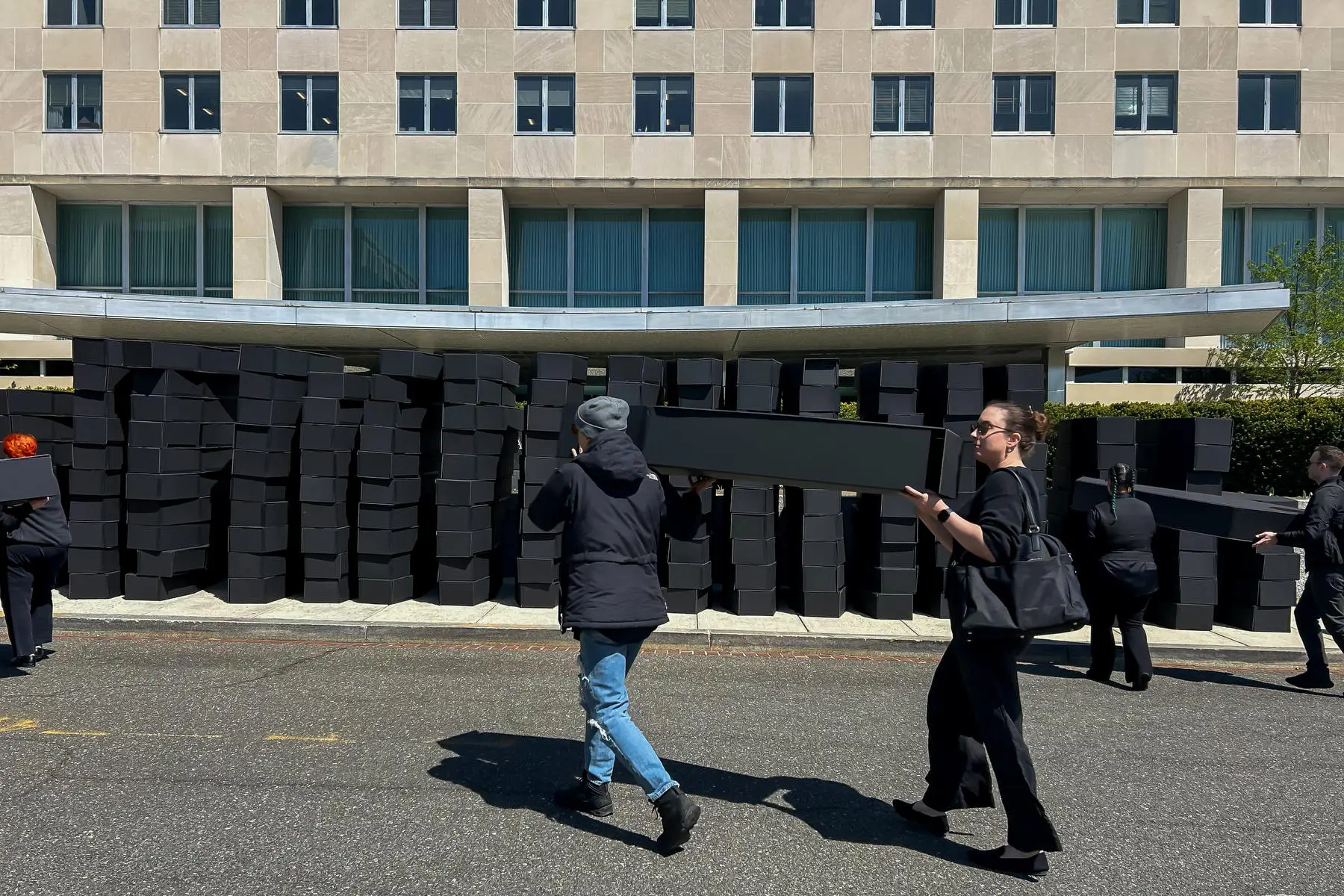 Activists pile 200 coffins outside State Department to protest cuts to global AIDS relief